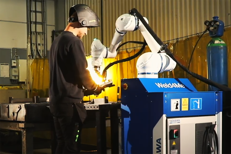 Man standing in front of a welding cell with a cobot called Weld4Me